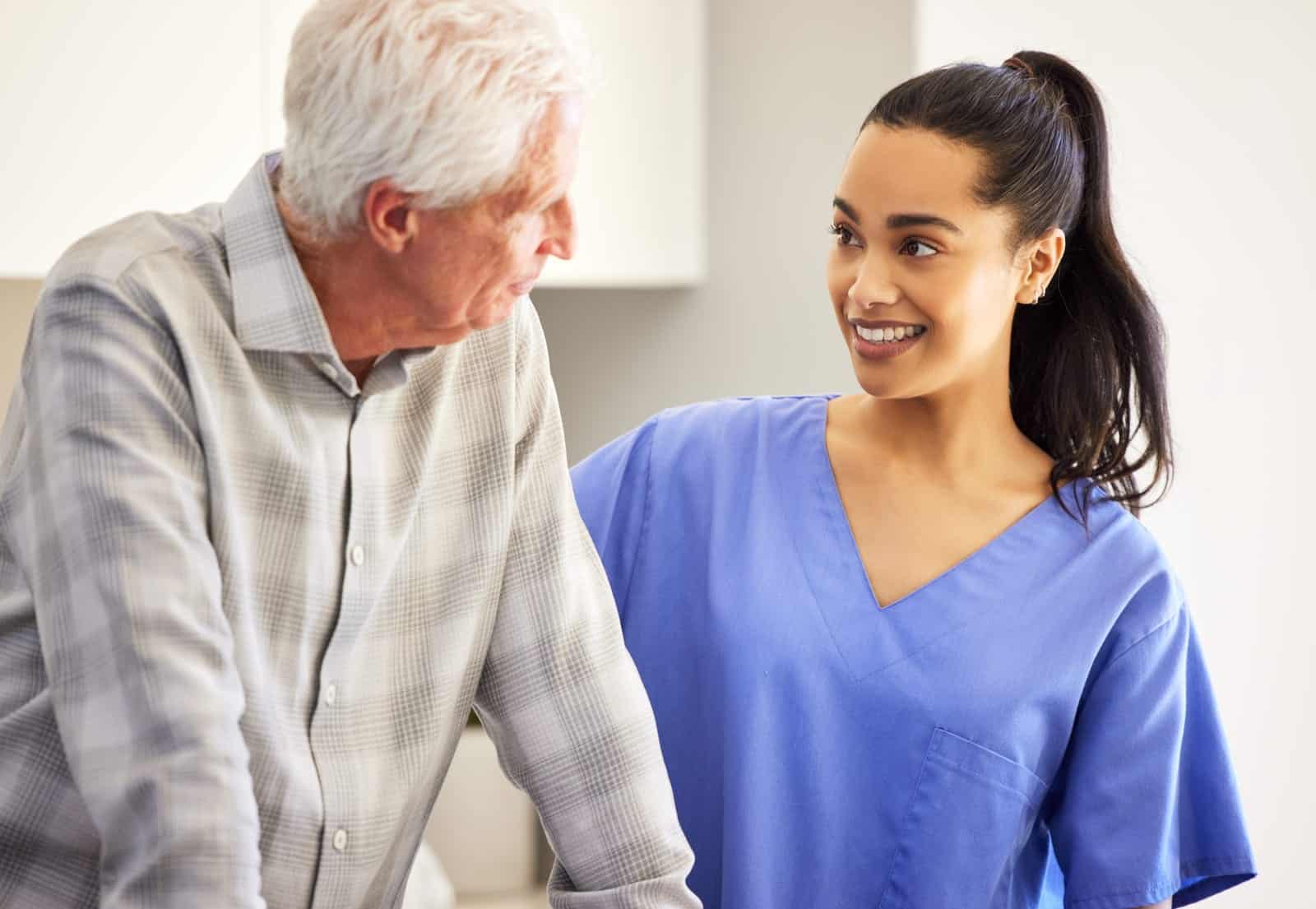 elderly care giver with man and nurse in home woman